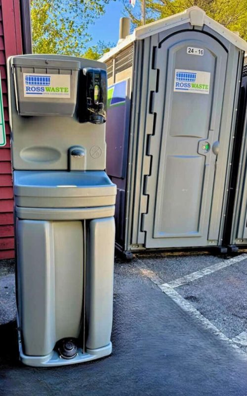 Ross Waste Hand Wash Station next to a porta potty